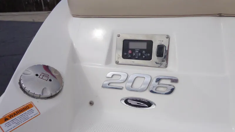 Slide: The Image of 2011 Chaparral 206 SSi boat dashboard with control panel and warning label. - 4