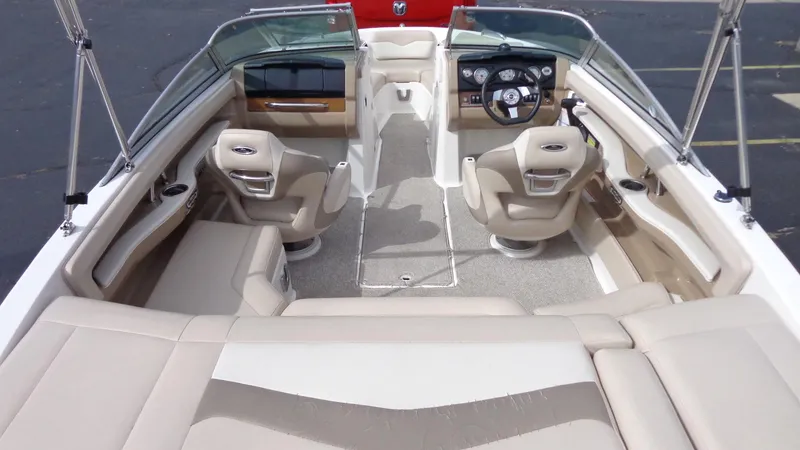 Slide: The Image of 2011 Chaparral 206 SSi boat interior with beige seating and steering console. - 7