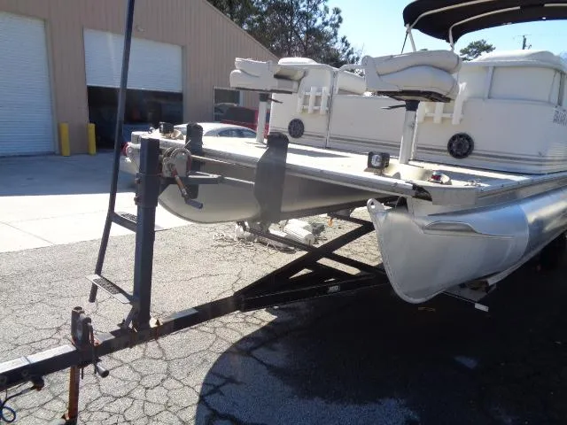 Slide: The Image of 2004 Sylvan SUNCHASER 824 pontoon boat on a trailer in a parking lot. - 12