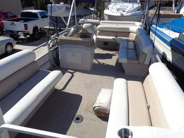 Slide: The Image of 2004 Sylvan SUNCHASER 824 pontoon boat interior with beige seating and helm station. - 14