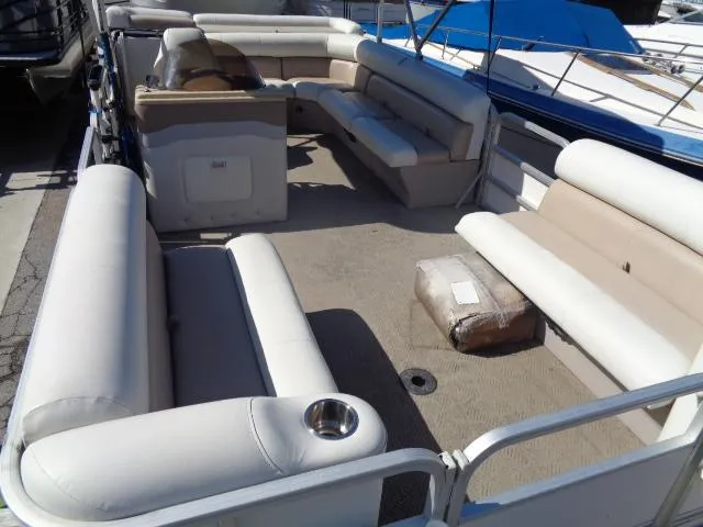 Slide: The Image of 2004 Sylvan SUNCHASER 824 pontoon boat with spacious seating and beige upholstery. - 15
