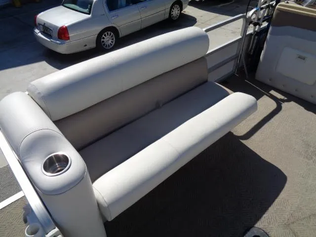 Slide: The Image of 2004 Sylvan SUNCHASER 824 boat interior with cushioned seating and cup holder. - 17