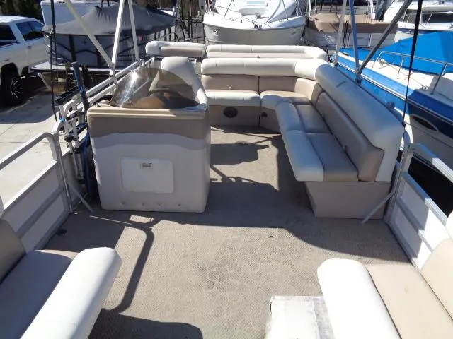 Slide: The Image of 2004 Sylvan SUNCHASER 824 pontoon boat interior with beige seating and helm station. - 20