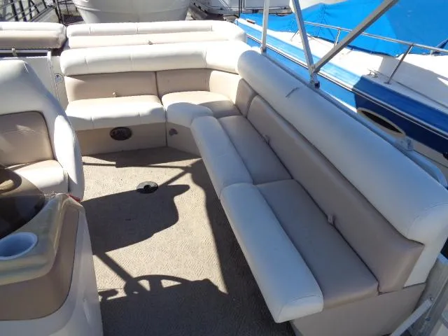 Slide: The Image of 2004 Sylvan SUNCHASER 824 pontoon boat interior with beige seating and carpet. - 21