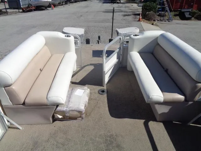 Slide: The Image of 2004 Sylvan SUNCHASER 824 pontoon boat interior with beige and white seating. - 6
