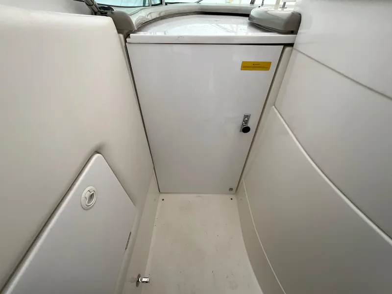 Slide: The Image of 2002 Cruisers Express boat interior, white cabin door and storage compartment. - 10