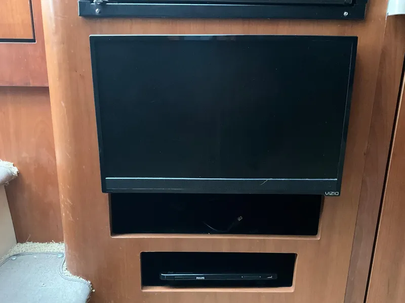 Slide: The Image of Flat-screen TV and DVD player in 2002 Cruisers Express boat interior. - 17