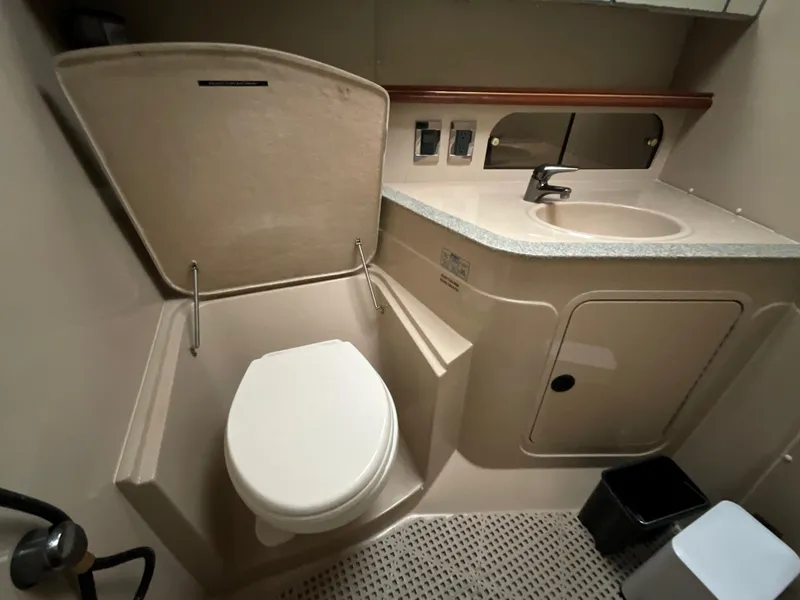 Slide: The Image of 2002 Cruisers Express boat bathroom with toilet, sink, and mirror. - 20
