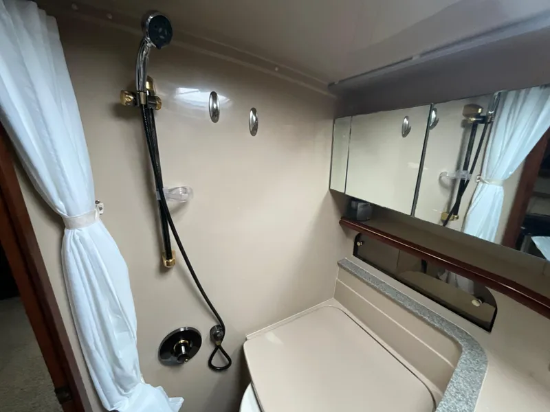 Slide: The Image of 2002 Cruisers Express bathroom with shower, mirror, and sink. - 21