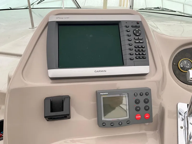 Slide: The Image of 2002 Cruisers Express boat dashboard with Garmin GPSmap 4210 and Raymarine ST60+ displays. - 3