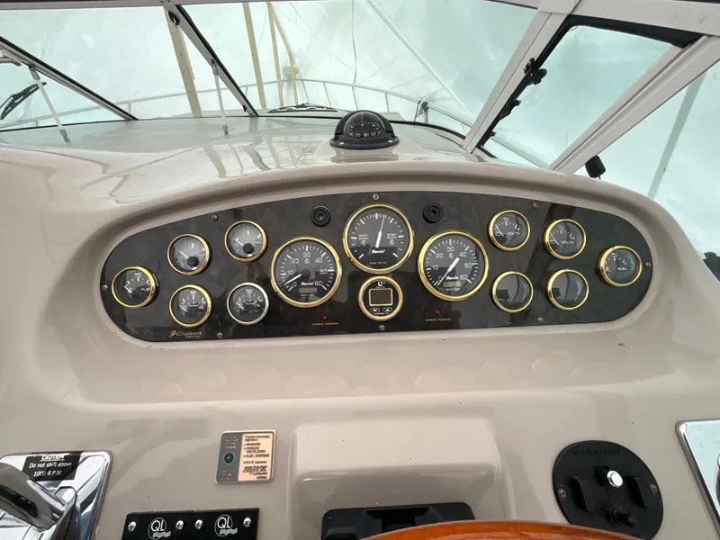 Slide: The Image of 2002 Cruisers Express boat dashboard with gauges and controls. - 6