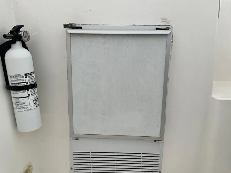 Slide: The Image of Fire extinguisher and vent on a 2002 Cruisers Express boat. - 9