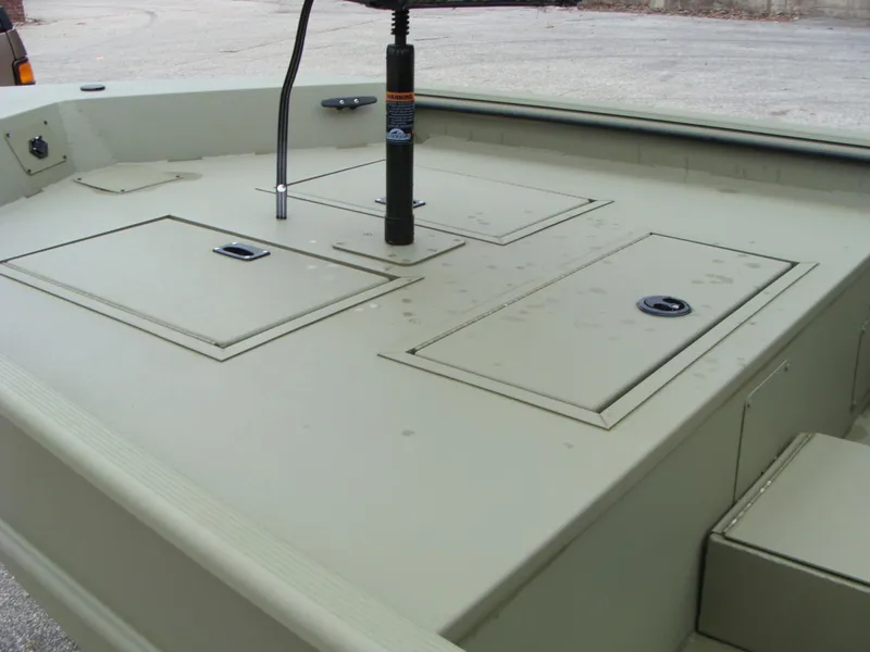 Slide: The Image of 2023 Lowe RX 1660 SC boat deck with storage compartments and seat base. - 10