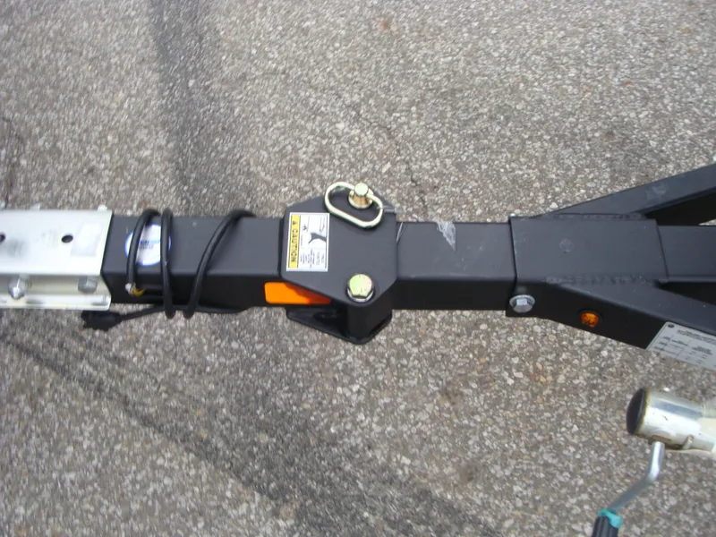 Slide: The Image of 2023 Lowe RX 1660 SC trailer hitch on asphalt. - 11