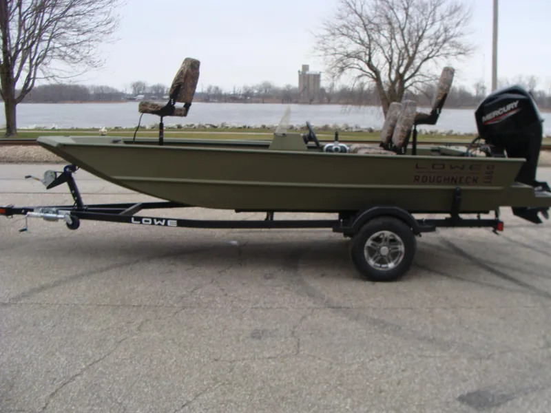 Slide: The Image of 2023 Lowe RX 1660 SC boat on trailer by a lake. - 5
