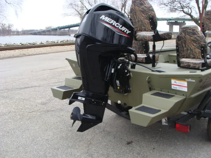 Slide: The Image of 2023 Lowe RX 1660 SC boat with Mercury outboard motor, camo seats, and river background. - 6