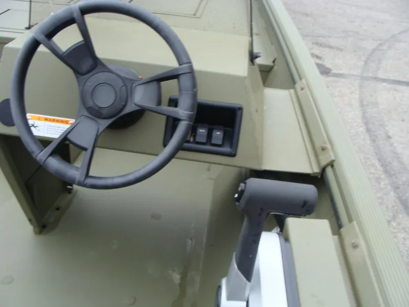 Slide: The Image of 2023 Lowe RX 1660 SC boat steering wheel and control panel. - 7