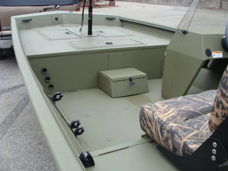 Slide: The Image of 2023 Lowe RX 1660 SC boat interior with camo seat and storage compartments. - 9