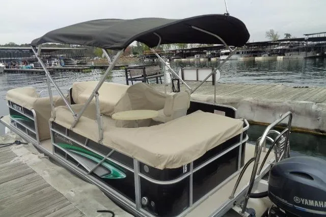 The Image of 2017 Godfrey Sweetwater pontoon boat docked, featuring covered seating and Yamaha outboard motor. - 25