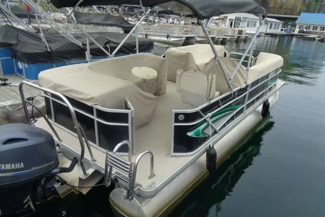 Slide: The Image of 2017 Godfrey Sweetwater pontoon boat docked, featuring covered seating and Yamaha outboard motor. - 27