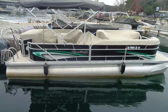 Slide: The Image of 2017 Godfrey Sweetwater pontoon boat docked, featuring a canopy and covered seating. - 28