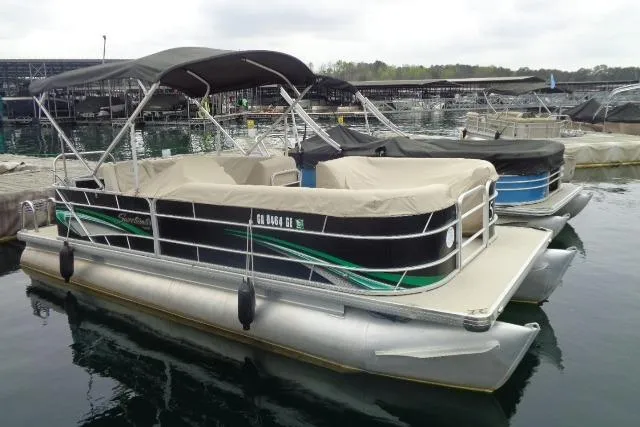 Slide: The Image of 2017 Godfrey Sweetwater pontoon boat docked on calm water with canopy and cover. - 29