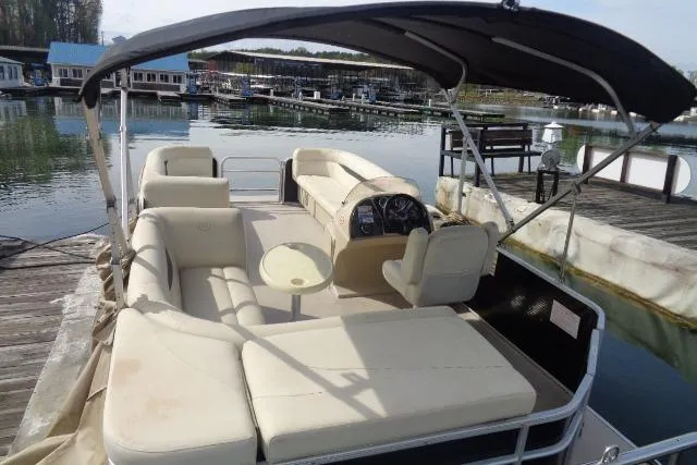 Slide: The Image of 2017 Godfrey Sweetwater pontoon boat docked, featuring spacious seating and canopy. - 31