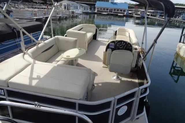 Slide: The Image of 2017 Godfrey Sweetwater pontoon boat with beige seating, docked at a marina. - 32