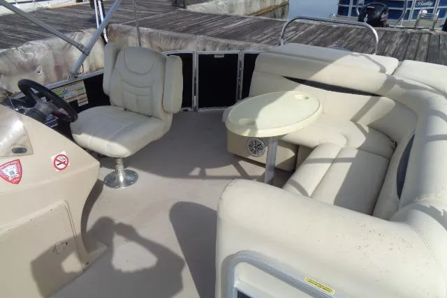Slide: The Image of 2017 Godfrey Sweetwater boat interior with beige seating and steering console. - 35