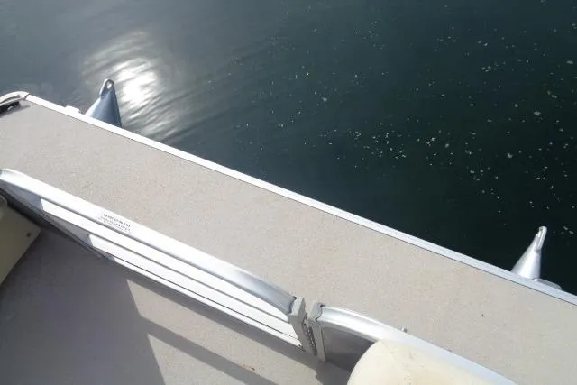 Slide: The Image of 2017 Godfrey Sweetwater pontoon boat deck overlooking calm water. - 39