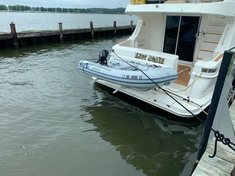 Slide: The Image of 2005 Silverton 38 Sport Bridge yacht docked with inflatable boat attached. - 1