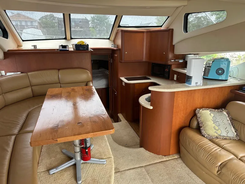 Slide: The Image of Interior of 2005 Silverton 38 Sport Bridge yacht with cozy seating and kitchenette. - 10