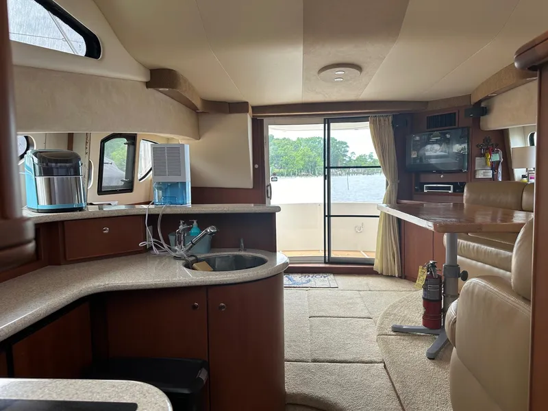 Slide: The Image of Interior of 2005 Silverton 38 Sport Bridge yacht with kitchen and seating area. - 11
