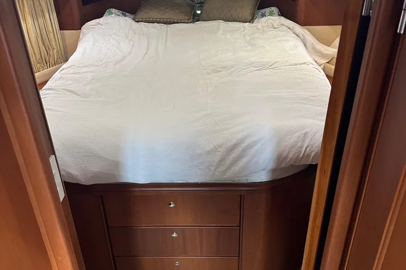Slide: The Image of 2005 Silverton 38 Sport Bridge cabin with bed and wooden storage drawers. - 12