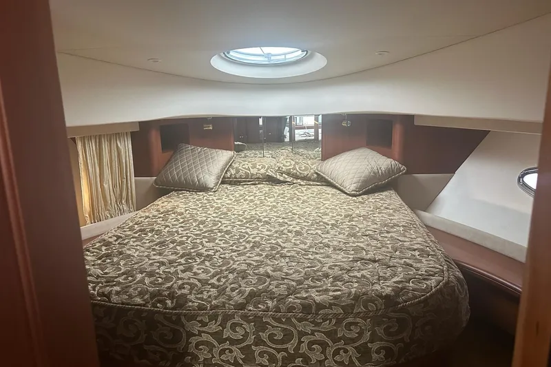 Slide: The Image of Luxurious bedroom interior of 2005 Silverton 38 Sport Bridge yacht with elegant bedding. - 18