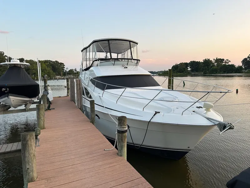 Slide: The Image of 2005 Silverton 38 Sport Bridge yacht docked at sunset. - 19