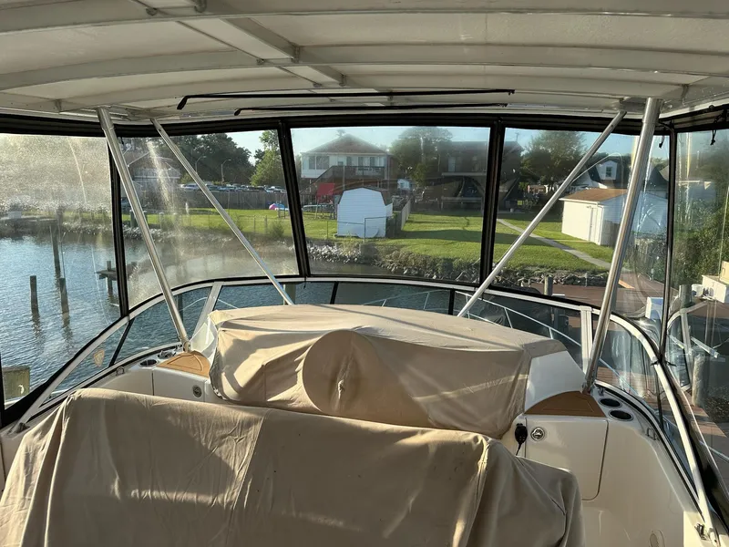 Slide: The Image of 2005 Silverton 38 Sport Bridge interior view with marina backdrop. - 5