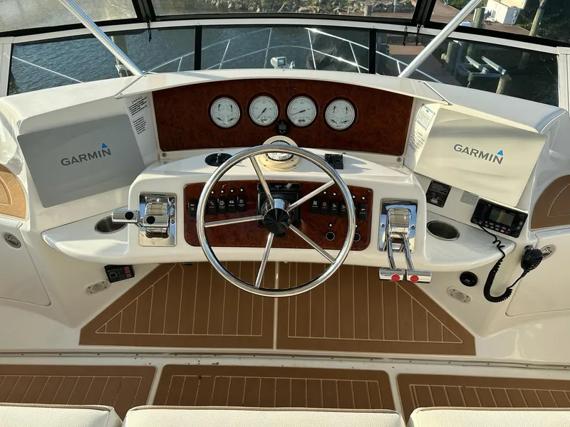 Slide: The Image of 2005 Silverton 38 Sport Bridge helm with Garmin navigation and classic wood accents. - 7