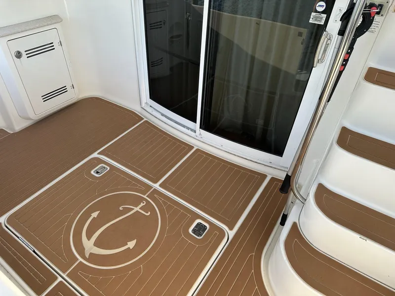 Slide: The Image of 2005 Silverton 38 Sport Bridge deck with anchor design and sliding glass door. - 9