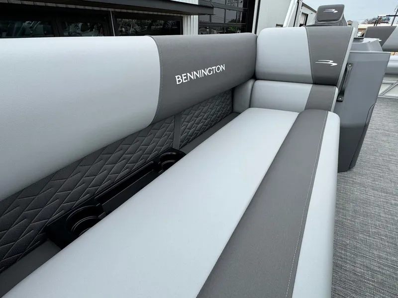 Slide: The Image of 2024 Bennington 22 S Swingback boat seat with gray upholstery and cup holders. - 16