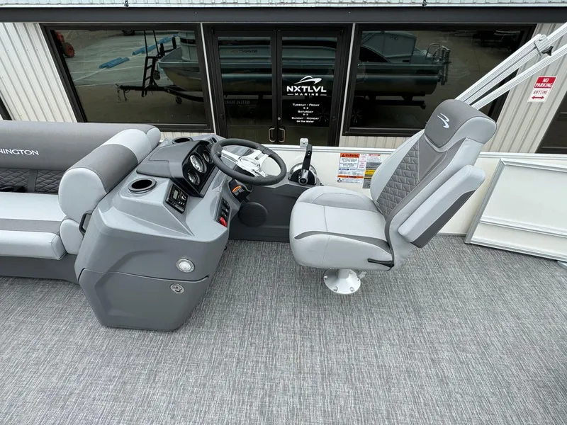 Slide: The Image of 2024 Bennington 22 S Swingback boat interior with steering console and captain's chair. - 18