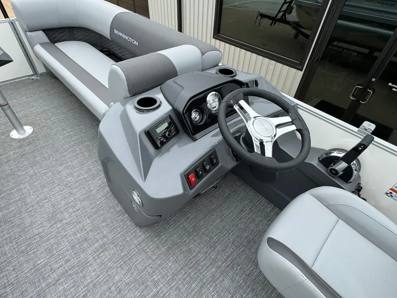 Slide: The Image of 2024 Bennington 22 S Swingback boat interior with steering console and seating. - 19