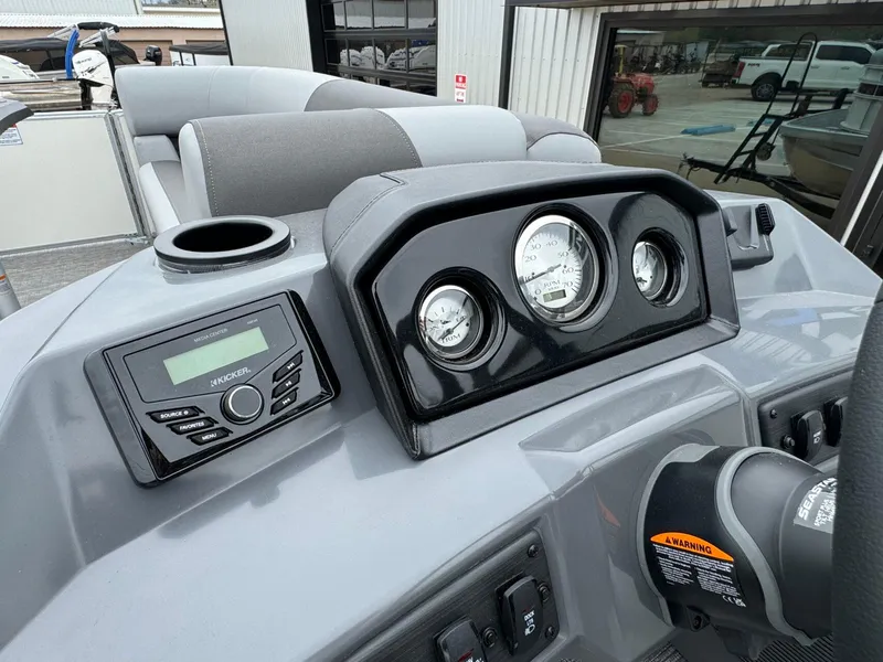 Slide: The Image of 2024 Bennington 22 S Swingback dashboard with gauges and media center. - 21