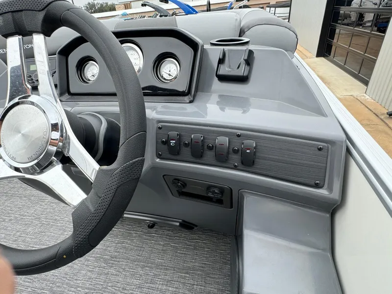 Slide: The Image of 2024 Bennington 22 S Swingback dashboard with steering wheel and control panel. - 23