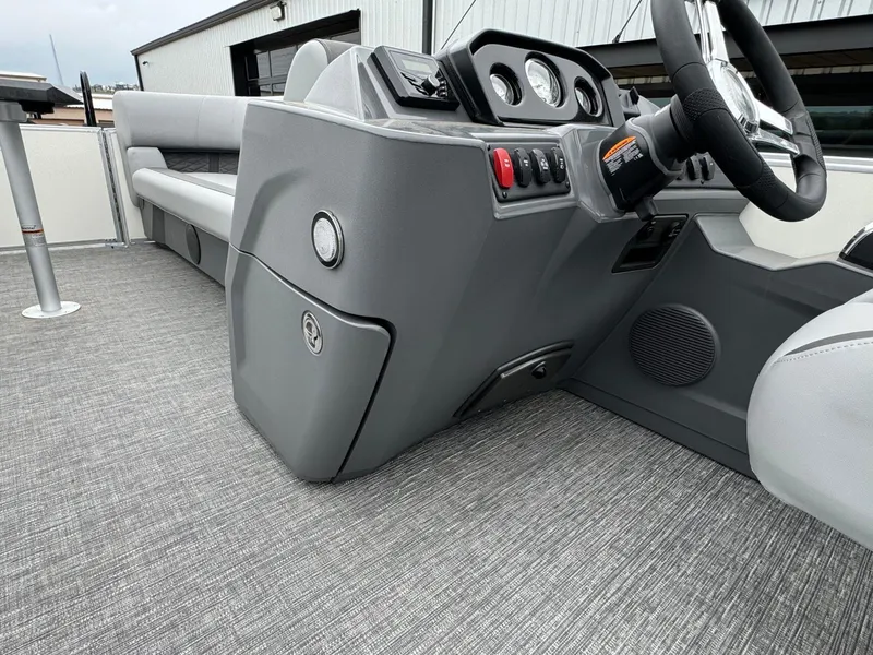 Slide: The Image of 2024 Bennington 22 S Swingback boat interior with gray dashboard and seating. - 24