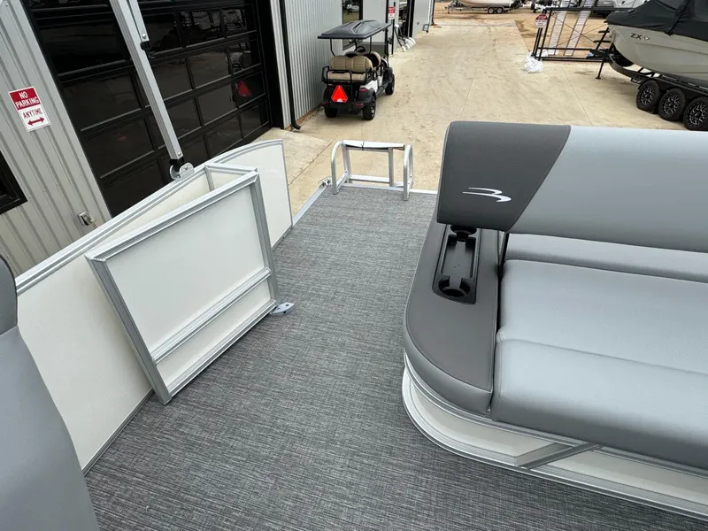 Slide: The Image of 2024 Bennington 22 S Swingback pontoon boat with gray seating and open deck area. - 28