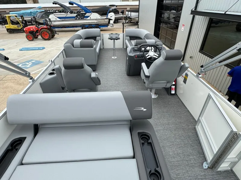 Slide: The Image of 2024 Bennington 22 S Swingback pontoon boat interior with gray seating and modern helm. - 30