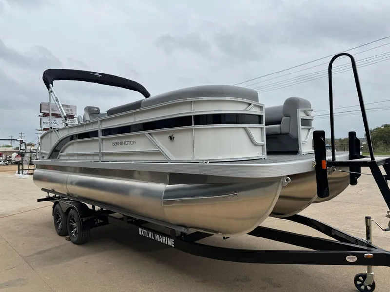 Slide: The Image of 2024 Bennington 22 S Swingback pontoon boat on trailer, outdoor display. - 8