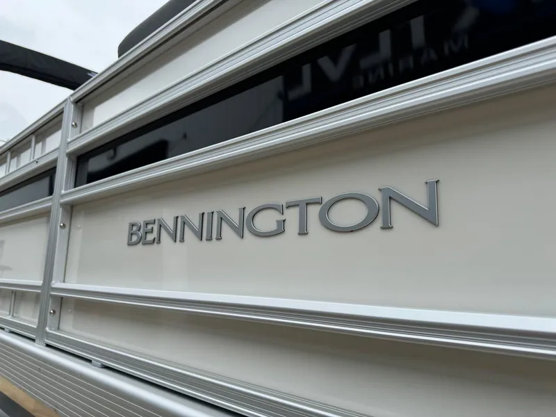 Slide: The Image of 2024 Bennington 22 S Swingback pontoon boat with sleek design and branding. - 9