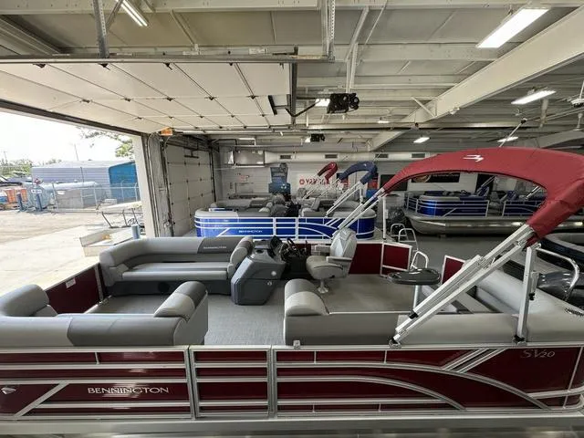 Slide: The Image of 2024 Bennington 20 SVL pontoon boat with red canopy in showroom. - 10